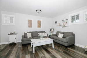 Living room with dark hardwood / wood-style flooring