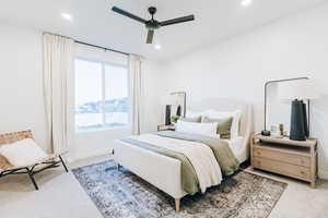 Carpeted bedroom featuring ceiling fan