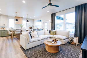 Living room with ceiling fan and light wood-type flooring