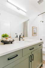 Bathroom with hardwood / wood-style floors, vanity, and toilet