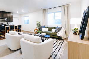 Living room with sink and light wood-type flooring