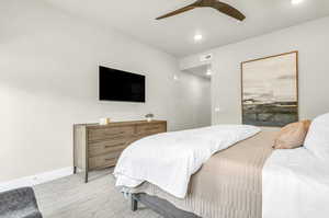 Carpeted bedroom with ceiling fan