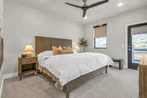 Carpeted bedroom featuring access to exterior and ceiling fan