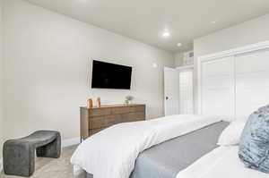 Bedroom with a closet and light colored carpet