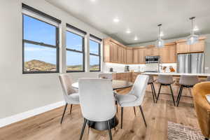 Dining area with light hardwood / wood-style flooring