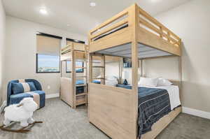 Bedroom featuring light colored carpet