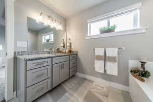 Bathroom with tile patterned flooring and vanity