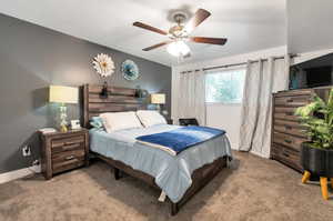 Bedroom with light colored carpet and ceiling fan