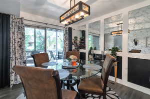 Dining space with hardwood / wood-style flooring