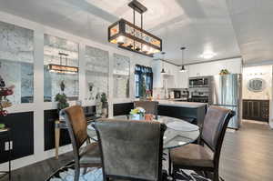 Dining area featuring a notable chandelier and hardwood / wood-style floors