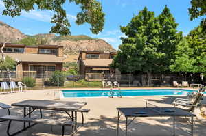 View of pool with a patio and a mountain view