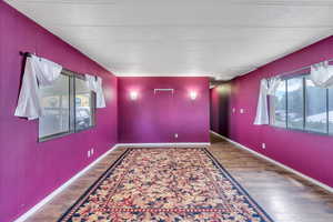 Spare room with dark wood-type flooring