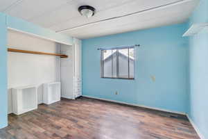 Unfurnished bedroom featuring hardwood / wood-style flooring and a closet