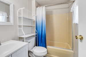 Full bathroom with shower / tub combo, toilet, and vanity