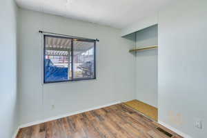 Unfurnished room with hardwood / wood-style flooring