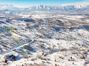 Snowy aerial view featuring a mountain view