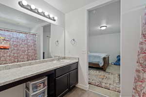 Bathroom with vanity and hardwood / wood-style flooring