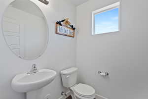 Bathroom featuring sink and toilet