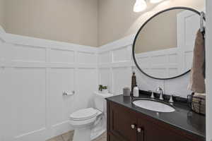 Bathroom with tile patterned floors, toilet, and vanity