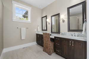 Master Bathroom with vanity, tasteful backsplash, and tile patterned floors