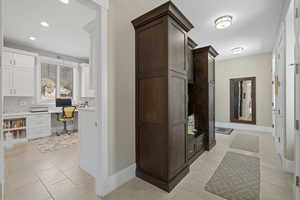 Interior space featuring light tile patterned floors  Incredible built in cabinet