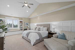 Bedroom featuring light colored carpet, high vaulted ceiling, and ceiling fan