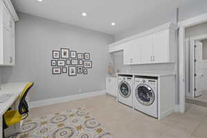 Washroom with cabinets, independent washer and dryer, and light tile patterned floors  2nd Office