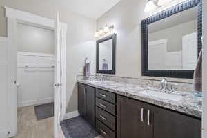 Bathroom with tile patterned flooring and double sink vanity