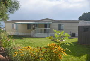 backyard with shed and covered deck