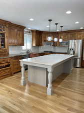 This Chef's gourmet kitchen with its stainless steel appliances, light hardwood floor and deep copper sink is easy to work in and a favorite place to gather.