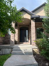 Stately front porch nestled in manicured foliage.