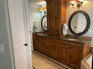 Enjoy the double sink vanity and tile  flooring as you get ready for your day in this relaxing spa like bathroom.