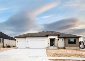 Prairie-style home featuring a garage