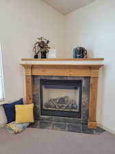 Room details featuring a tiled gas fireplace