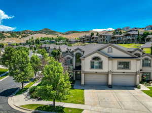 View of Twi home featuring a mountain view and a two car garage