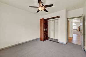 Bedroom, custom bookshelf bifold door conceals a closet, and ceiling fan