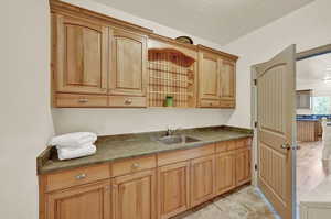 Laundry room with sink and lots of storage! Solid wood cabinetry.