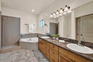 Full main bathroom featuring dual vanity, shower with separate bathtub, toilet, and tile patterned floors