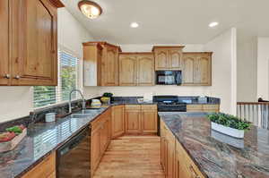 Kitchen with granite countertops, roll out shelves in large island.