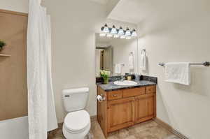 Full Bathroom featuring vanity, tile patterned flooring, and toilet