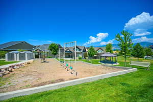 View of jungle gym with a gazebo and a lawn