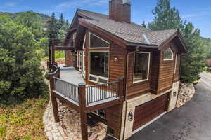 Exterior space with a garage and a wooden deck