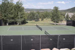 View of tennis court featuring a mountain view