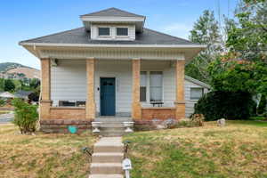 Bungalow-style house featuring a front lawn