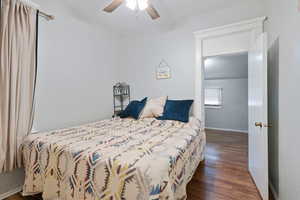 Bedroom with ceiling fan and dark hardwood / wood-style flooring