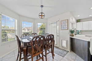 Dining room with light tile patterned flooring