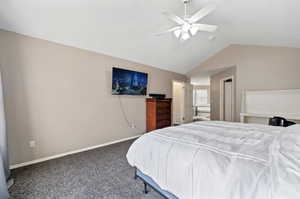 Carpeted bedroom with lofted ceiling and ceiling fan