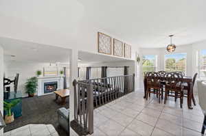 Dining area with a tile fireplace and light tile patterned floors