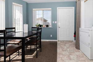 Tiled dining space with washer / dryer