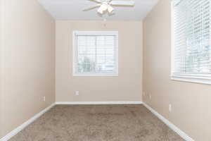 Empty room with carpet and ceiling fan